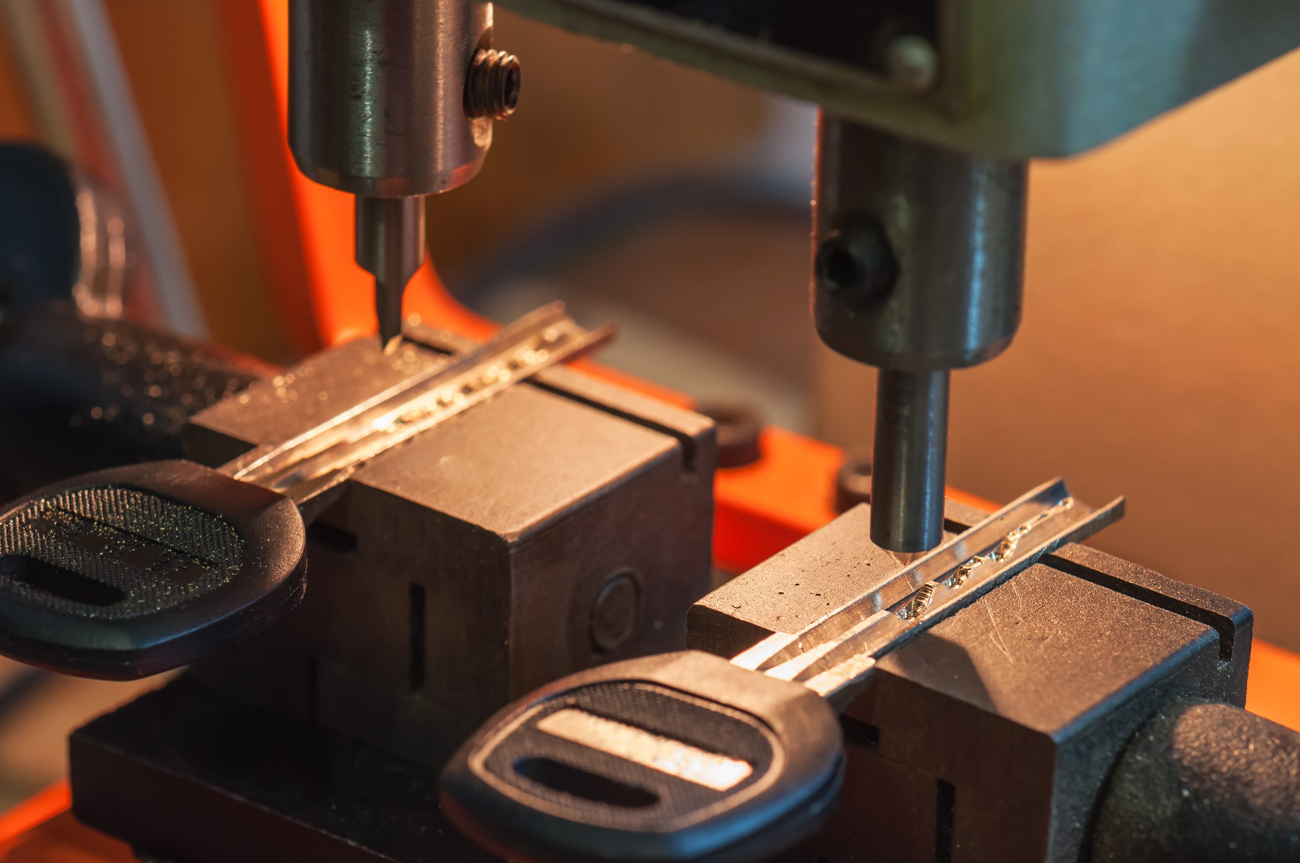 Key cutting machine shaping a key